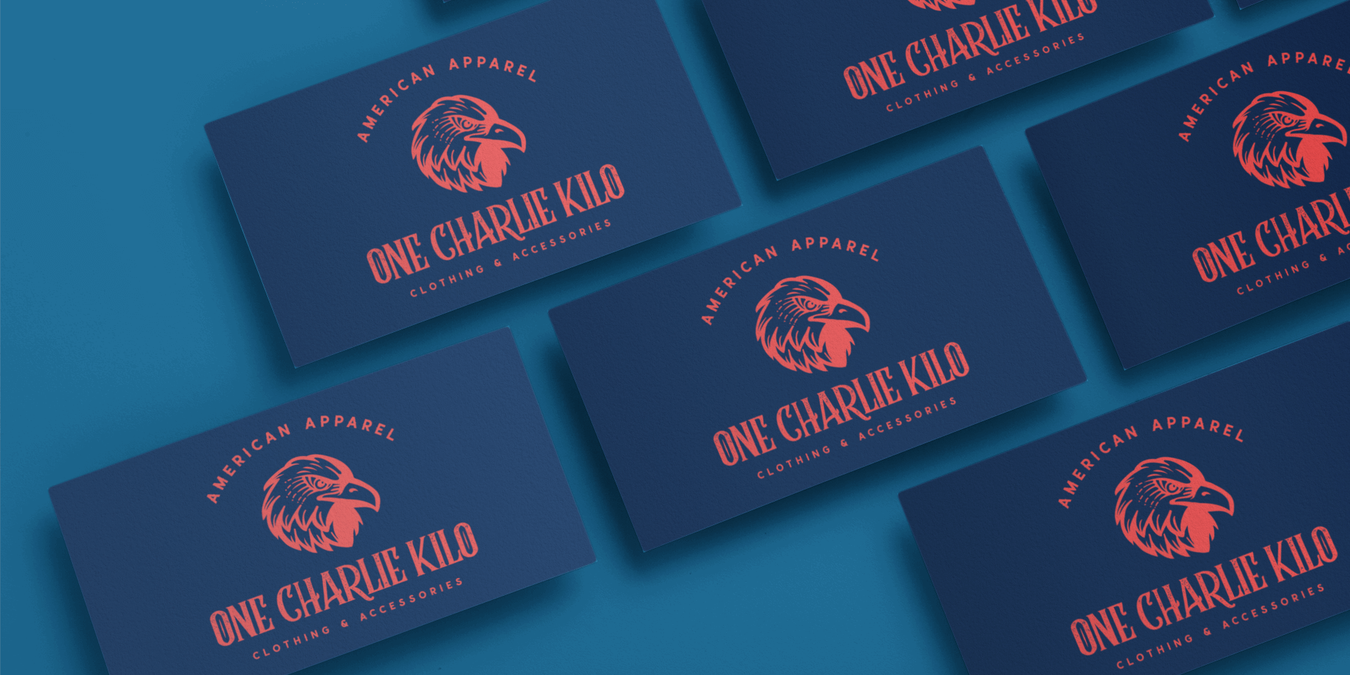 One Charlie Kilo Logo Business Cards on blue background with shadow