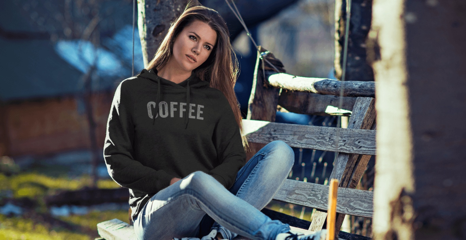 Coffee Hoodie Women's Grey woman sitting on a park bench in the sun